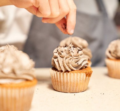 faceless-chef-decorating-cupcakes-on-table-2023-11-27-05-32-08-utc